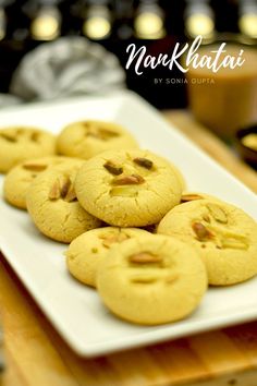 some cookies are on a white plate and have pistachios in the middle