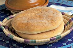 a close up of a sandwich on a plate with a bowl and spoon in the background