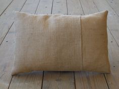 a brown pillow sitting on top of a wooden floor