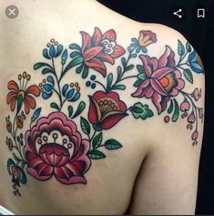 the back of a woman's shoulder with flowers on it