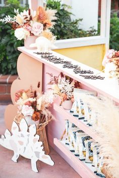 a pink bench with flowers and decorations on it