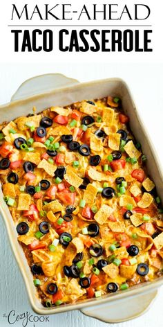 a casserole dish with black olives, tomatoes and cheese