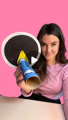 a woman is holding a paper plate and a megaphone