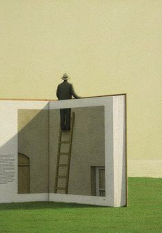 a man standing on top of a giant open book in the middle of a field