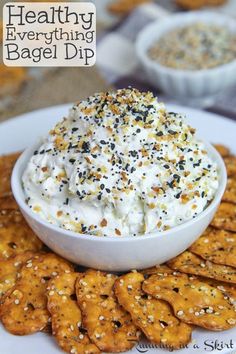 a white plate topped with crackers and dip