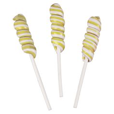 three yellow and white striped lollipops sitting on top of eachother