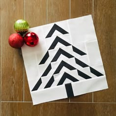 an ornament and two ornaments on a piece of paper