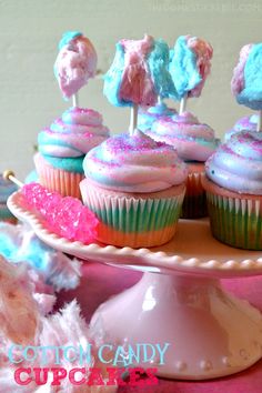 cupcakes with colorful frosting are on a cake plate