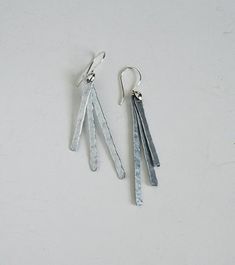 "I hand hammered aluminum into these lovely dangle earrings.   They are extremely light weight! They have movement and catch the light beautifully. The earring hooks are silver plated copper. These earrings hang approximately 2 3/4\" * Complementary necklace to these earrings: https://www.etsy.com/listing/243232455/silver-boho-necklace-hammered-aluminum?ref=shop_home_active_59&sca=1 More Earrings: https://www.etsy.com/shop/BocadeJewelry?section_id=8004916 Bocade Handcrafted Jewelry shop home: https://www.etsy.com/shop/BocadeJewelry?ref=si_shop Bracelets: https://www.etsy.com/shop/BocadeJewelry?section_id=8004917 Necklaces: https://www.etsy.com/shop/BocadeJewelry?section_id=8004918 Rings: https://www.etsy.com/shop/BocadeJewelry?section_id=8036968 Anklets: https://www.etsy.com/shop/BocadeJew Hand Forged Dangle Earrings For Everyday, Hammered Metal Adjustable Earrings, Adjustable Hammered Metal Earrings, Long Drop Hand Forged Metal Earrings, Hand Forged Metal Long Drop Earrings, Hand Forged Long Drop Metal Earrings, Minimalist Hammered Dangle Earrings, Hand-forged Long Drop Metal Earrings, Everyday Hand Forged Metal Earrings