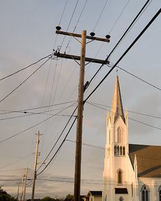 an old church with power lines in the foreground