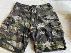 "Choice of two pairs of baggy, beachy unisex shorts, both size Large: Camouflage shorts, which laying flat measures 19\" across the middle and 24.5\" across at the hips And Blue Tie Dye long shorts, which laying flat measure 19\" across the waist and 22.5\" at the hips. Also, please take a look at my storefront at: https://www.etsy.com/shop/FabFinds42?ref=seller-platform-mcnav I have a wide selection of one-of-a-kind items, from clothing and toys to home decor and gift items, and I add new thing Beach Cargo Shorts For Summer, Beach Casual Cargo Shorts, Summer Beach Cargo Shorts With Built-in Liner, Camouflage Outdoor Shorts For Summer, Camouflage Shorts For Outdoor Summer Activities, Summer Camouflage Shorts For Outdoor, Camouflage Summer Shorts, Camouflage Outdoor Summer Shorts, Summer Outdoor Camouflage Shorts