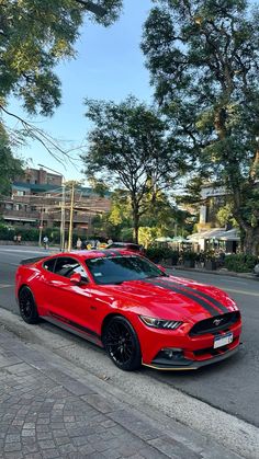 a red sports car parked on the side of the road