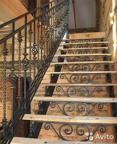 the stairs are made of wood and wrought iron