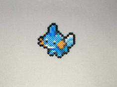 an image of a pixelated blue bird on a white surface with space in the background