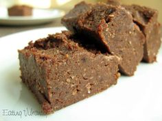 two pieces of brownie sitting on top of a white plate next to each other