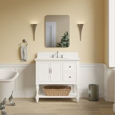 a bath room with a tub a sink and a mirror on the wall in it