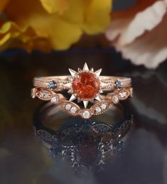 a close up of a ring on a table with flowers in the background