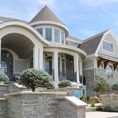 a large white house with stone steps leading up to it