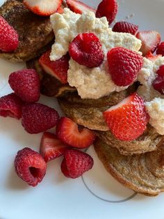 two pieces of toast with whipped cream and strawberries on top