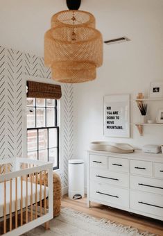 a baby's room with a crib and dresser