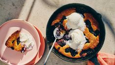 a skillet filled with blueberry cobbler and ice cream