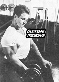 a man is doing exercises with dumbbells in a gym room, black and white photo