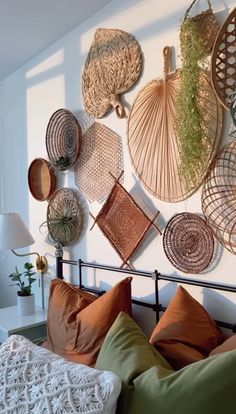 a bed with lots of baskets hanging on the wall