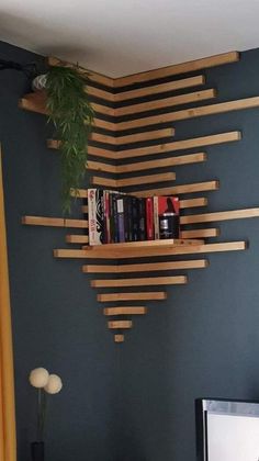 a bookshelf made out of wooden planks in the corner of a room