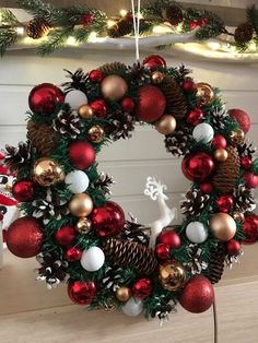 a christmas wreath with ornaments hanging from it