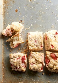 several squares of food sitting on top of a baking sheet covered in crumbs