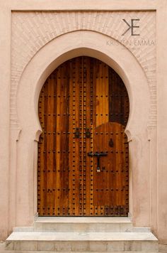 two large wooden doors in front of a building