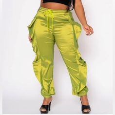 Trendy High Fashion Plus Size Women's Pants In High Waist Style, Drawstring Hem Waistline, Ruffle Trim Design, Functional Pockets, Ankle Cuffs And Soft Satin Material With A Sheen To It. -High Stretch 90% Polyester 10% Spandex Size 3x Wide Leg Stretch Joggers For Spring, Spring Stretch Wide Leg Joggers, Spring Wide Leg Stretch Joggers, High Waist Stretch Joggers For Spring, High-waist Green Ruffled Bottoms, Green High-waist Ruffled Bottoms, Casual Green Ruffled Bottoms, Trendy Solid Joggers For Spring, Spring Cargo Pants With Cuffed Ankles