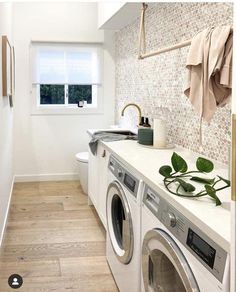 the laundry room is clean and ready to be used as a washer or dryer