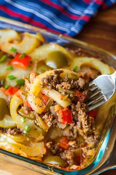 a glass casserole dish filled with vegetables and meat, ready to be eaten