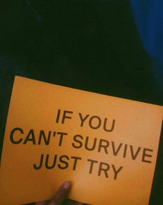 someone holding up a yellow sign that says if you can't survive just try