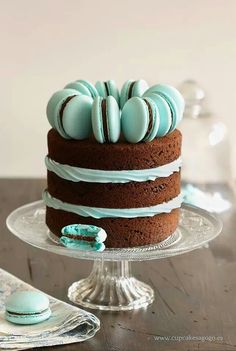 a chocolate cake with blue frosting on a glass plate