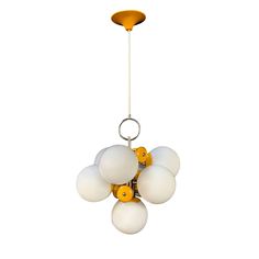 a chandelier with five white and yellow balls hanging from it's center