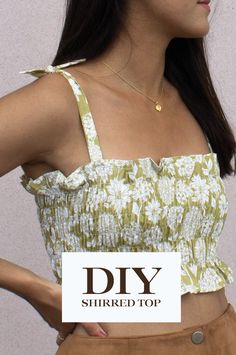 a woman with her hands on her hips wearing a top that says diy shred top