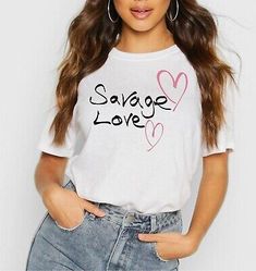 a woman wearing a white t - shirt with the words's love written on it