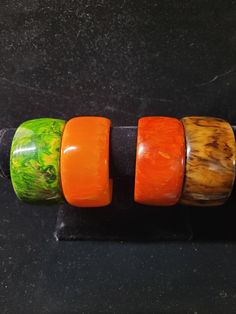 Wide, beautiful bakelite bangle bracelets. Bakelite, a precursor to plastic, was used in jewelry and other objects from the 1930's to the 1950's. These bracelets show slight wear, consistent with age. They all have marbling to some extent. They are being sold individually at $165 , but if more than one is chosen, a discount will be given. They have been heat tested and guaranteed as authentic bakelite. Their inner diameter is 2 1/2 inches which is standard. Width is 1 3/8 inches. Handmade Bakelite Bangle Bracelet, Vintage Lucite Bangle Bracelet, Vintage Orange Bangle Bracelets, Handmade Bakelite Bracelets As Gift, Vintage Resin Bangle, Bakelite Bracelets, Bakelite Bangles, Marbling, Bangle Bracelets