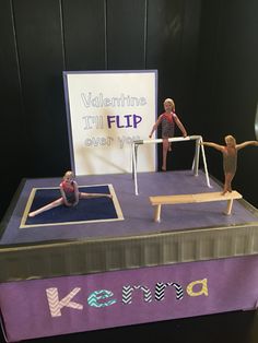 three figurines are sitting on top of a table with a sign that says valentine's flip