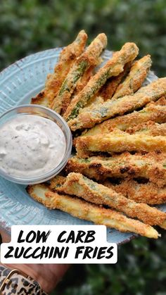 low carb zucchini fries on a blue plate with ranch dip in the middle