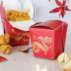 two red boxes with gold dragon designs on them