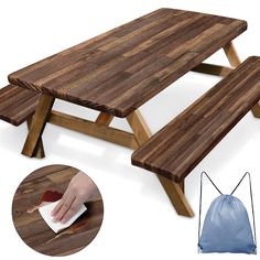 a wooden picnic table with a hand on it and a blue bag next to it