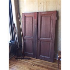 two wooden doors sitting next to each other on top of a hard wood floor