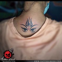 a woman with a tattoo on her neck has an evil face and eyes behind her back