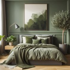 a bed with green sheets and pillows in a bedroom next to a painting on the wall