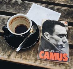 a cup of coffee sitting next to a book