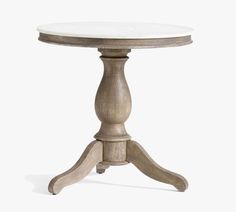 a white marble top table with wooden legs and an oval pedestal on the base is shown