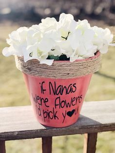 a pink flower pot with white flowers in it sitting on a wooden fence post, saying if bananas were flowers i'd pick you